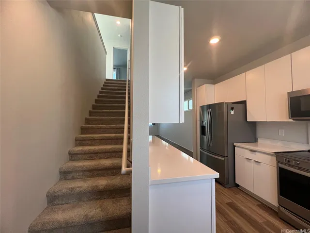 a view of kitchen with cabinets and stainless steel appliances