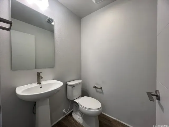 a bathroom with a sink mirror and toilet