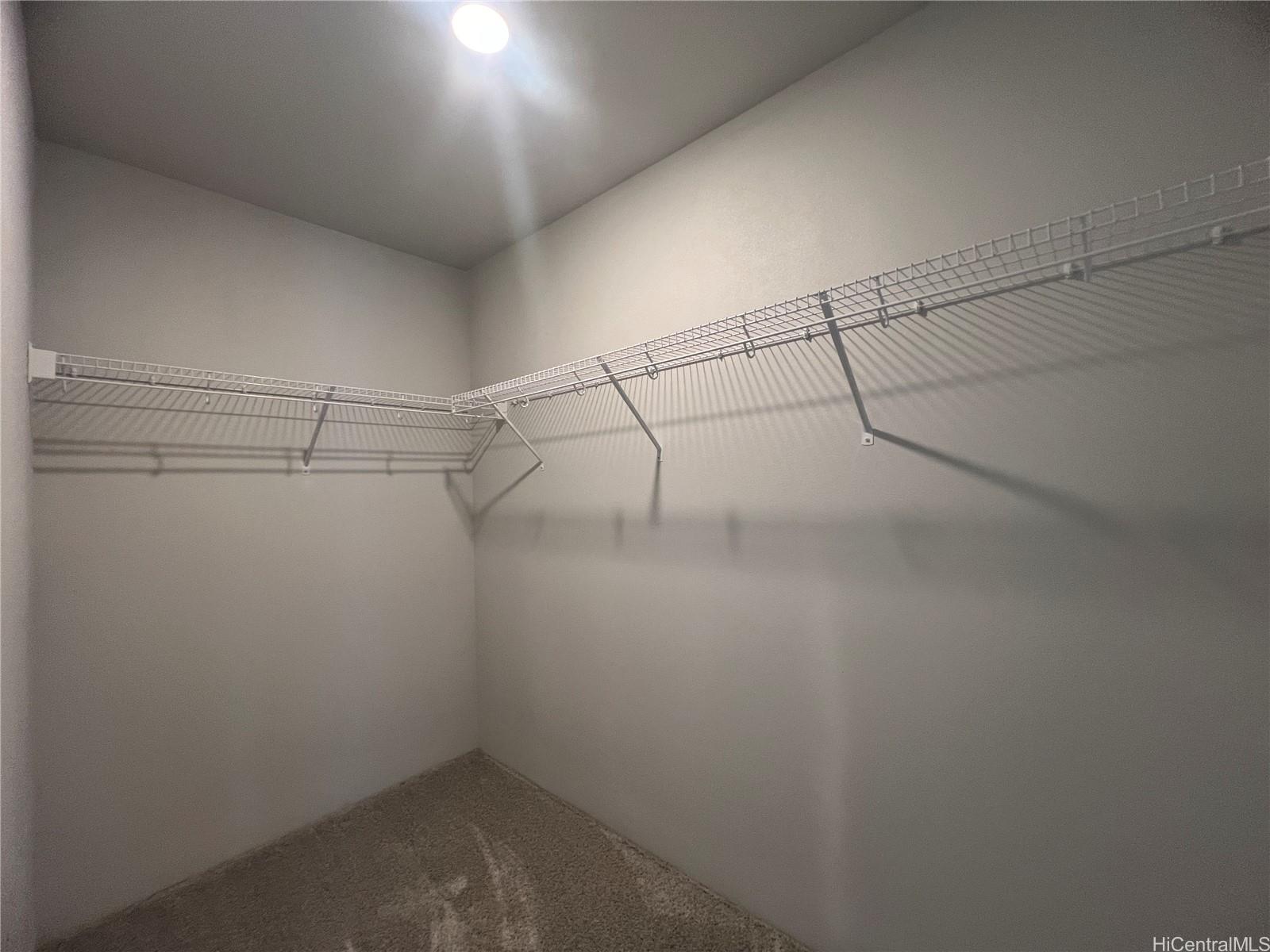 91-1640 Honouliuli Street, Unit 66 Ewa Beach, HI 96706 - Photo 8 of 20 a view of a room with racks on the wall