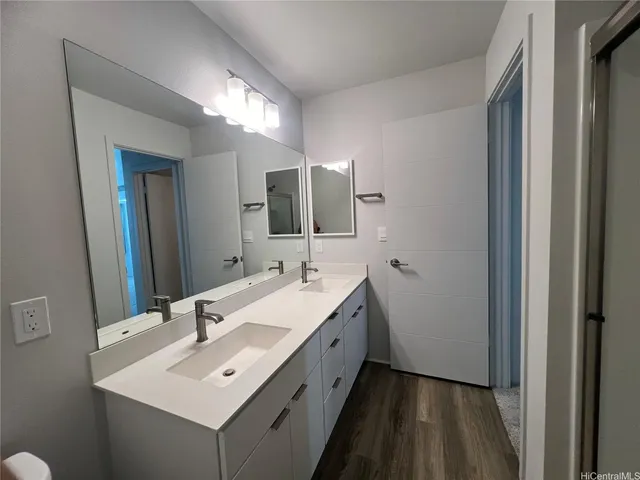 a bathroom with a double vanity sink and mirror