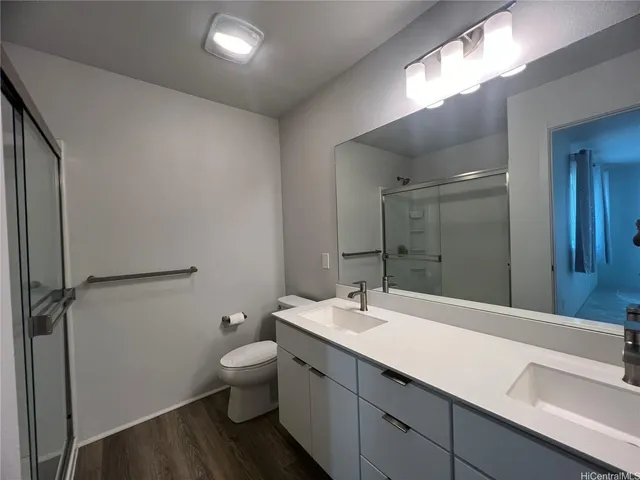 a bathroom with a sink a toilet and shower