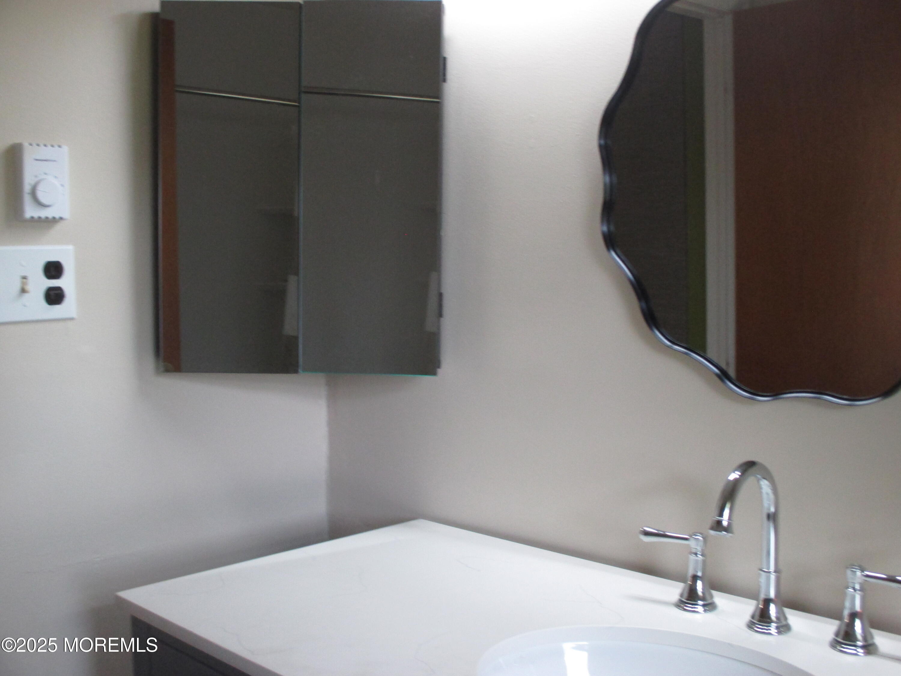 662 A Plymouth Drive Lakewood, NJ 08701 - Photo 17 of 21 a bathroom with a sink and a mirror