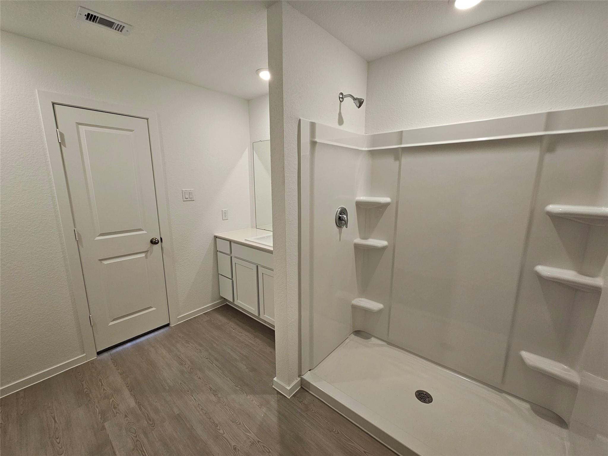17318 Roxboro Ridge Lane Crosby, TX 77532 - Photo 8 of 28 a bathroom with a glass shower door