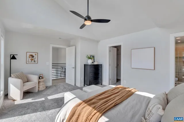 a bedroom with a bed and a couch