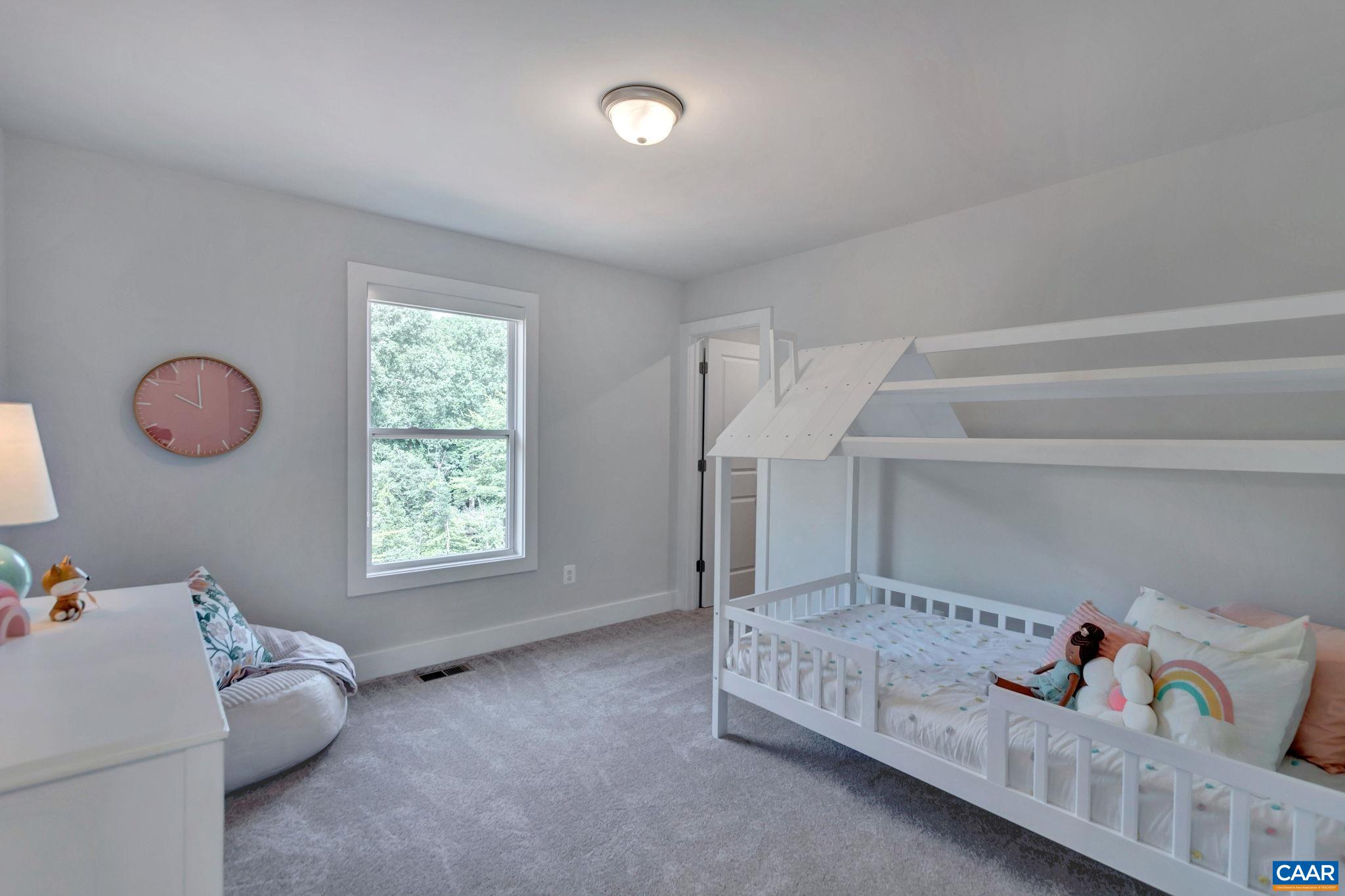 31 B Fowler Street Charlottesville, VA 22901 - Photo 18 of 26 a bedroom with furniture and a window