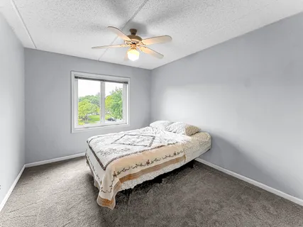 a bed sitting in a bedroom next to a window