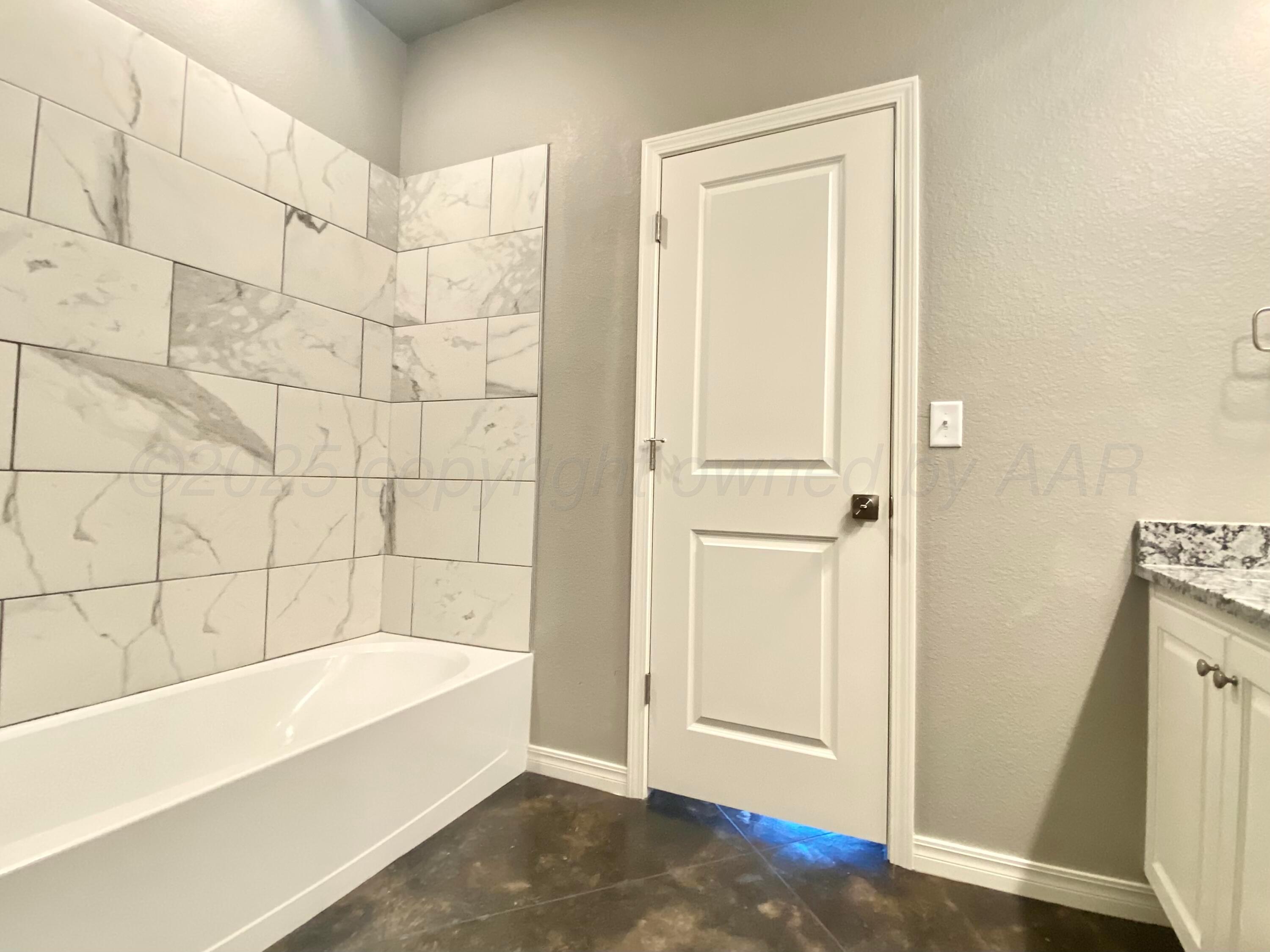 7517 John Thomas Street Amarillo, TX 79119 - Photo 12 of 20 a bathroom with a bathtub and shower