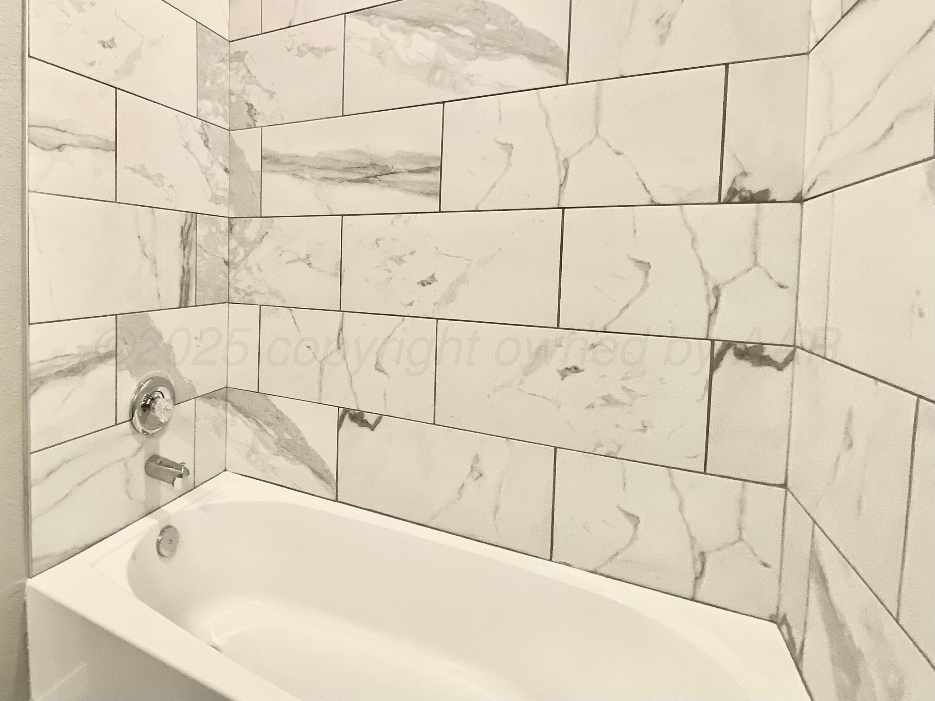 7517 John Thomas Street Amarillo, TX 79119 - Photo 15 of 20 a bathroom with a bathtub