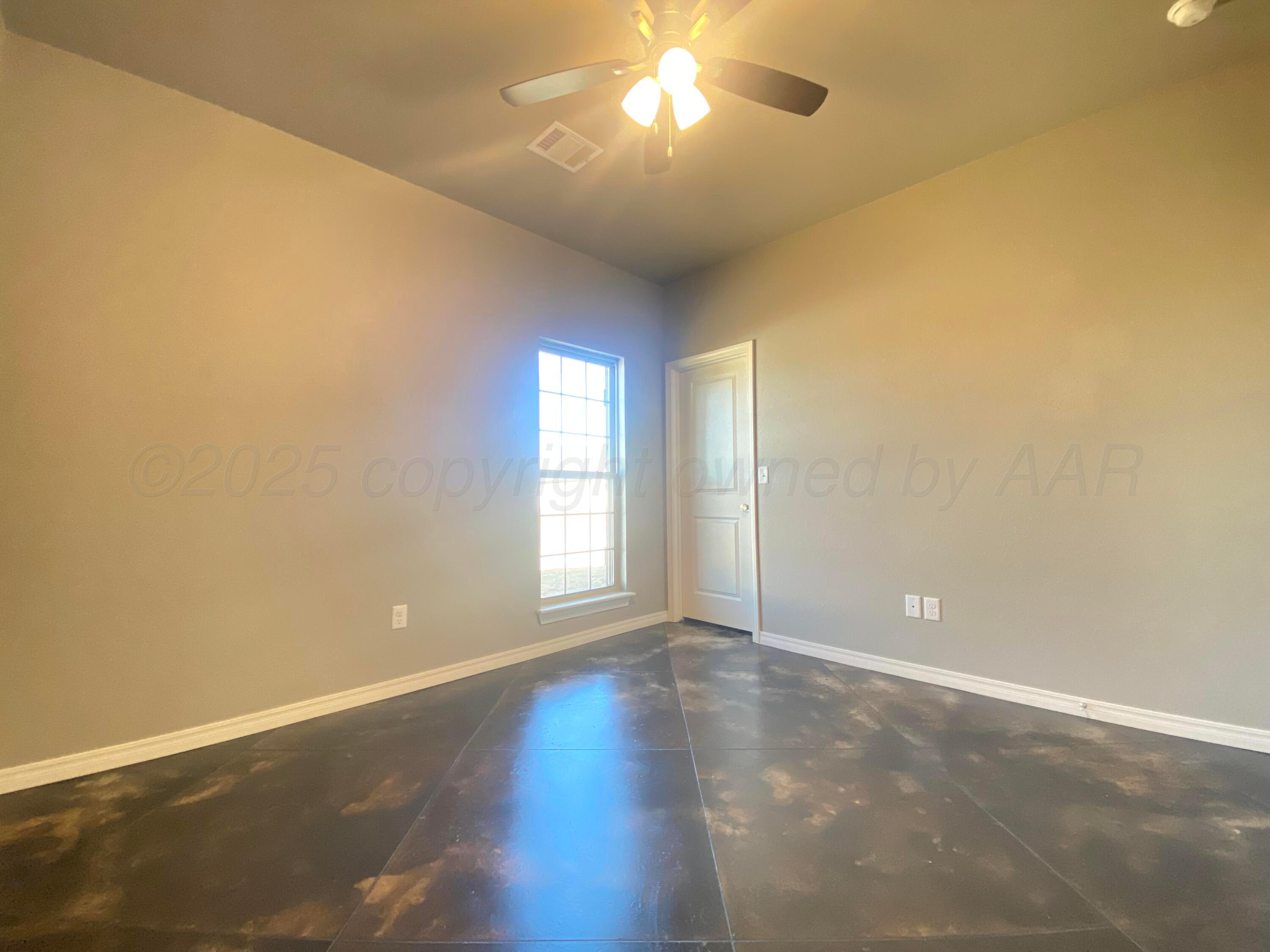 7517 John Thomas Street Amarillo, TX 79119 - Photo 16 of 20 a view of an empty room with a window and wooden floor