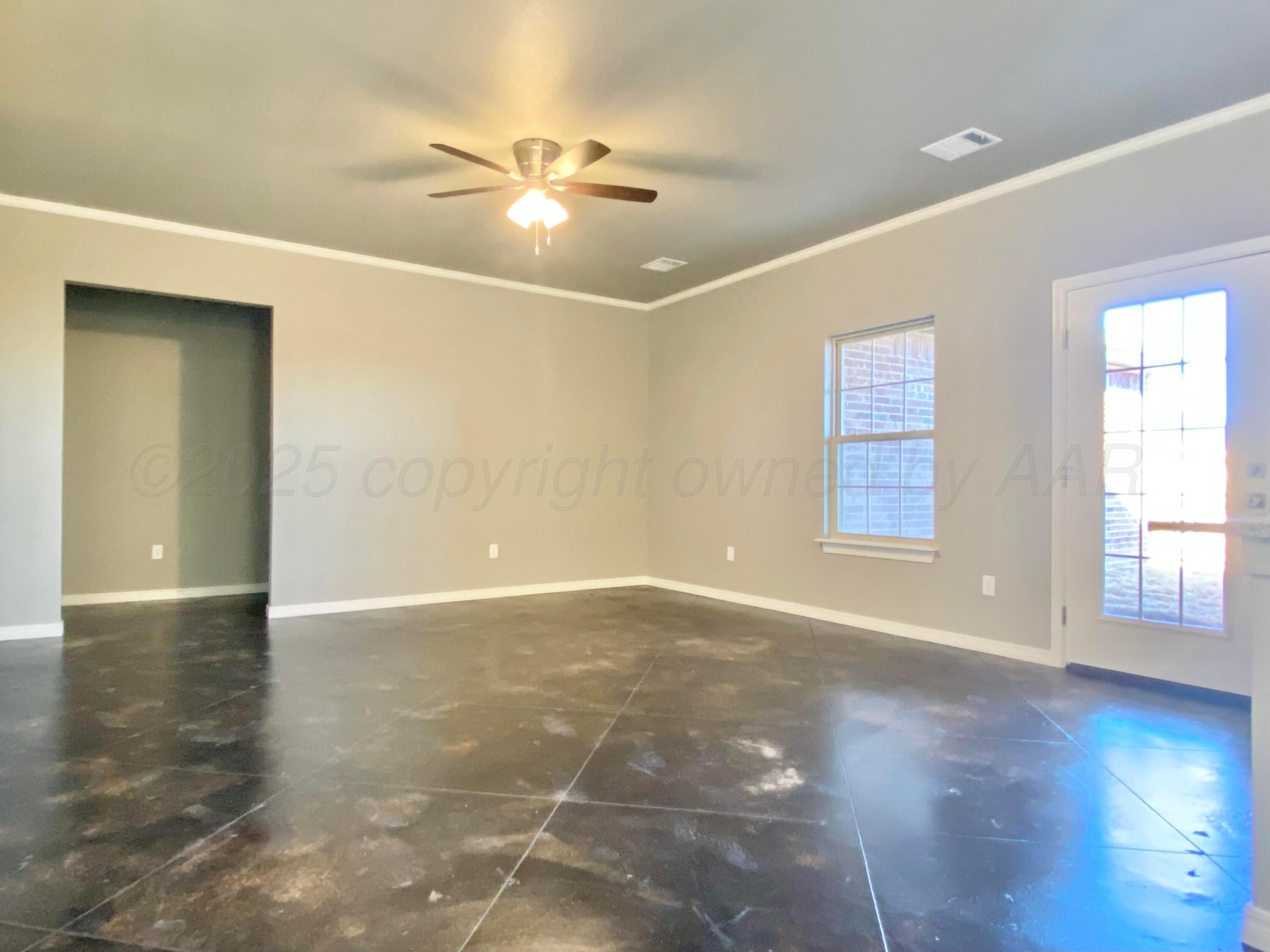7517 John Thomas Street Amarillo, TX 79119 - Photo 2 of 20 an empty room with wooden floor and windows