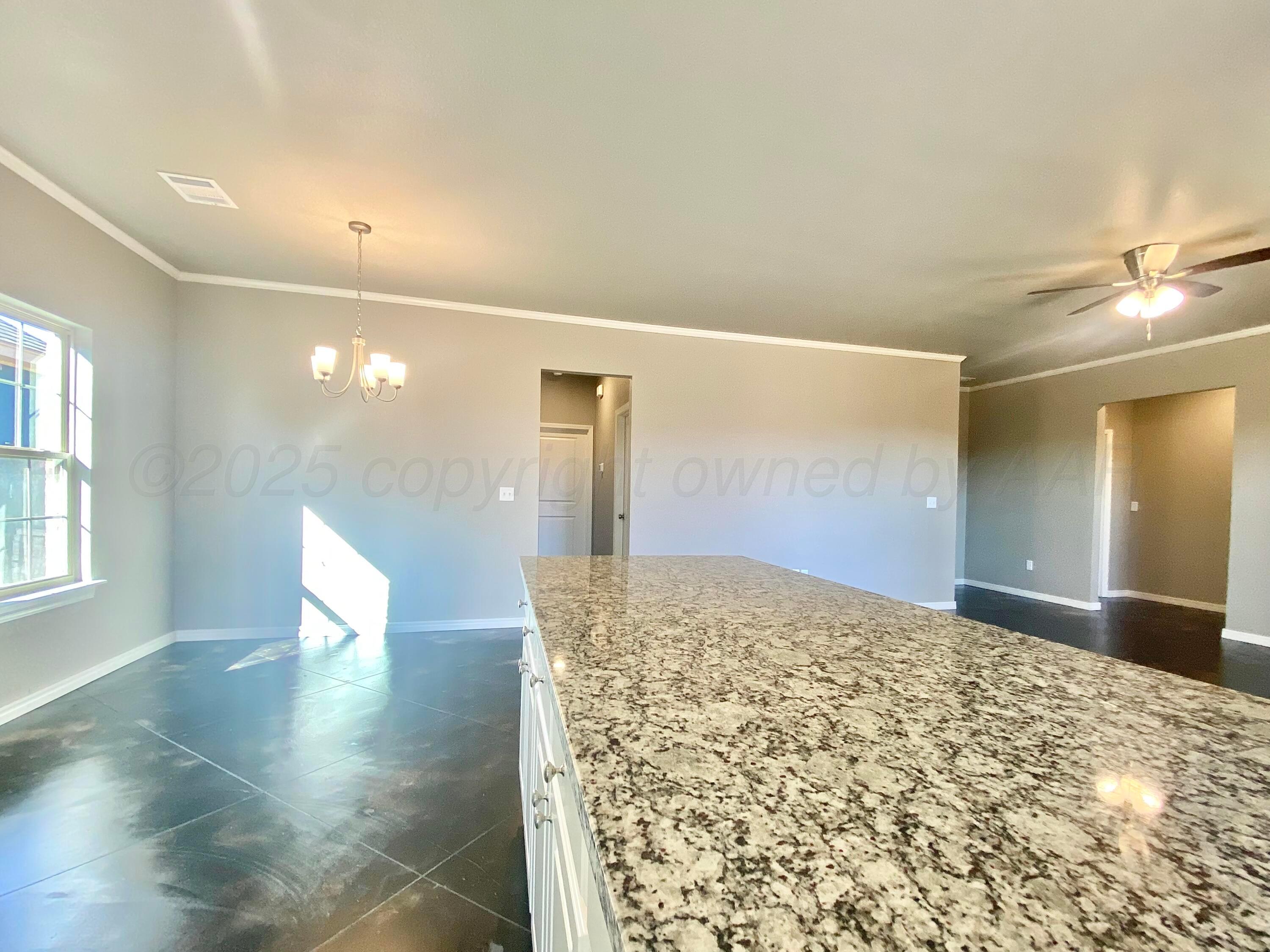 7517 John Thomas Street Amarillo, TX 79119 - Photo 8 of 20 a view of a big room with wooden floor and windows