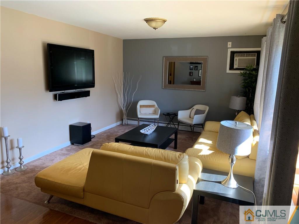 15 Sanders Road Edison, NJ 08817 - Photo 4 of 13 a living room with furniture and a flat screen tv