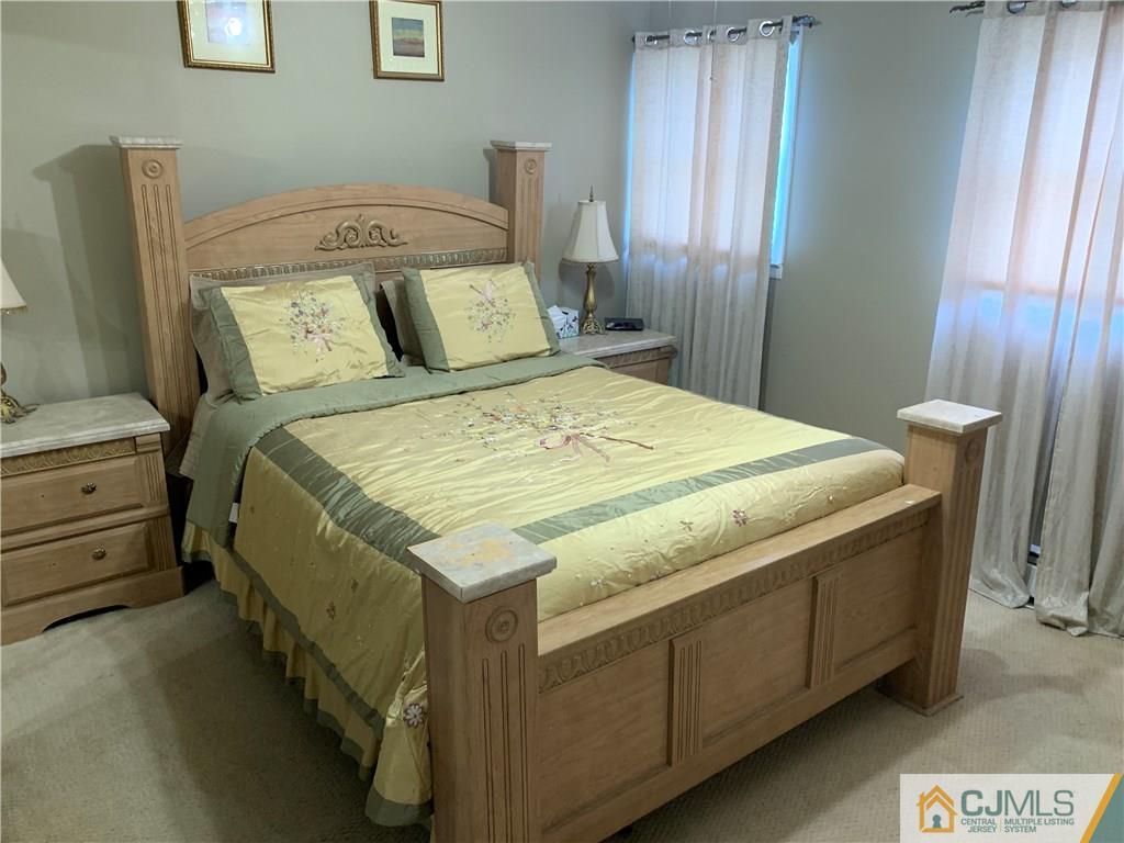15 Sanders Road Edison, NJ 08817 - Photo 7 of 13 a bed sitting in a bedroom next to a window