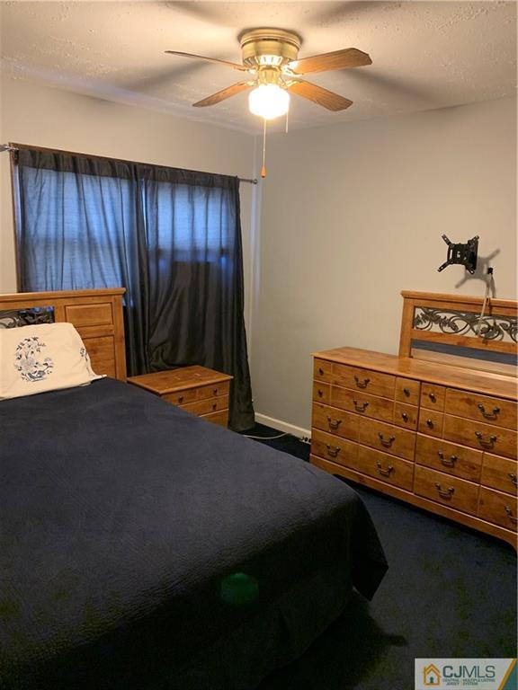 15 Sanders Road Edison, NJ 08817 - Photo 10 of 13 a bedroom with a bed and a chandelier