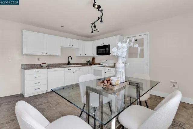 a living room with furniture and a painting on the wall