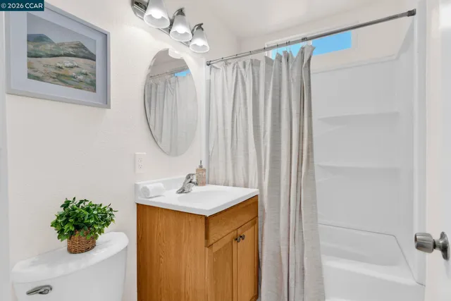 a view of a backyard with swimming pool and wooden fence