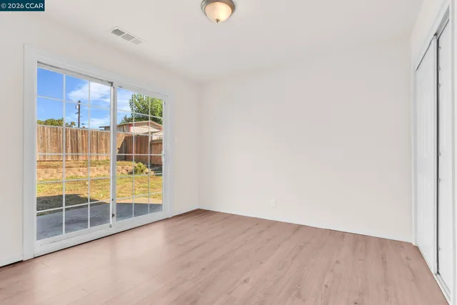 a view of a house with wooden fence