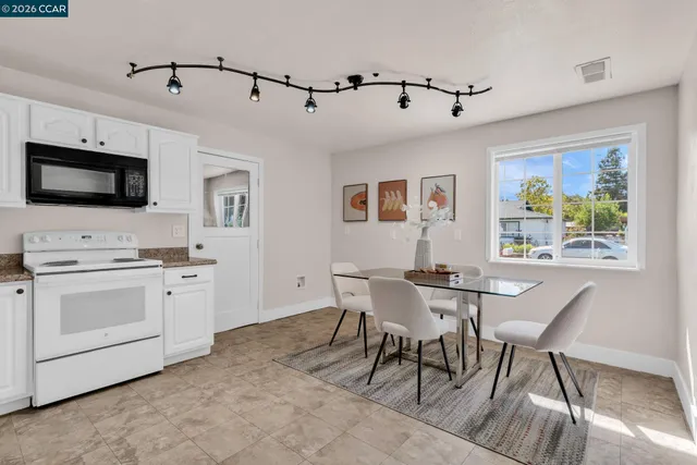 a dining room with furniture and window
