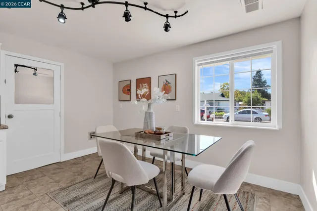 a kitchen with granite countertop white cabinets and stainless steel appliances