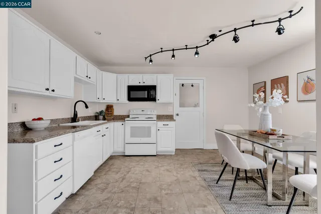 a kitchen with appliances a sink and cabinets