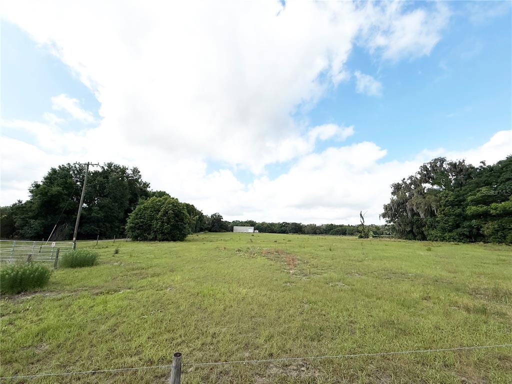 Southeast Sunset Harbor Road Weirsdale, FL 32195 - Photo 1 of 19 a view of a field with a view of beach