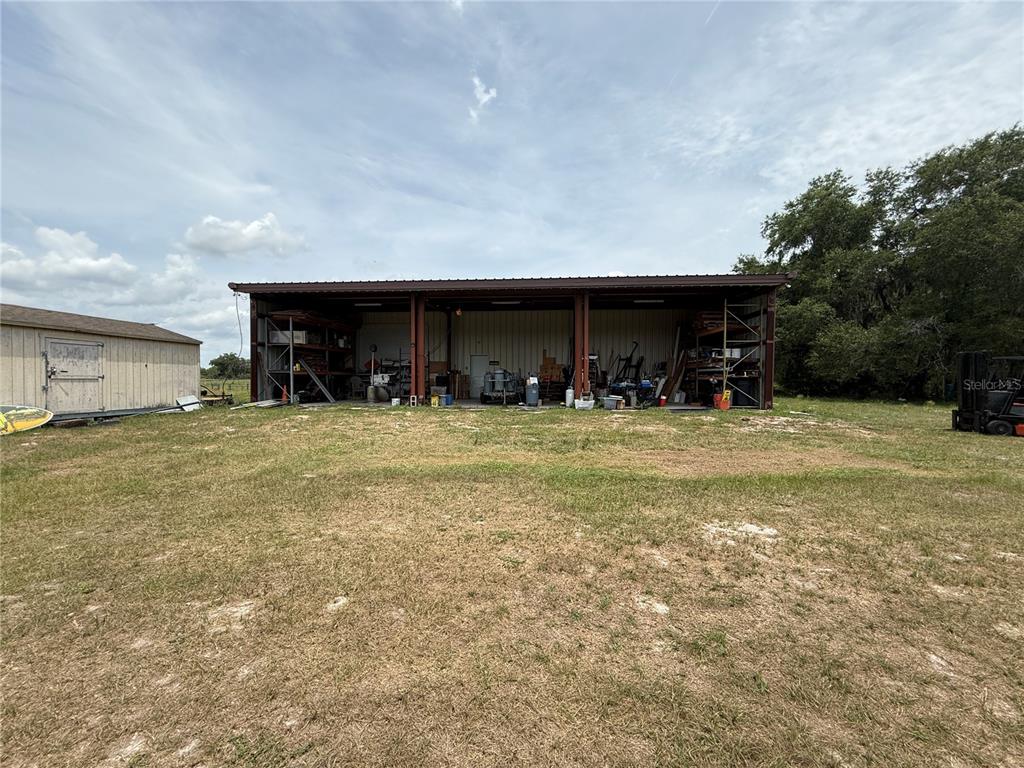 Southeast Sunset Harbor Road Weirsdale, FL 32195 - Photo 13 of 19 a view of a house with yard and trees in the background