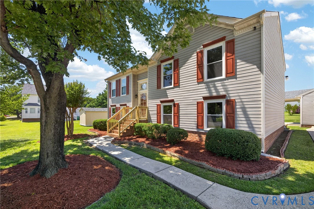 1559 Tree Ridge Road Henrico, VA 23231 - Photo 4 of 40 Light gray siding exterior with red window shutter