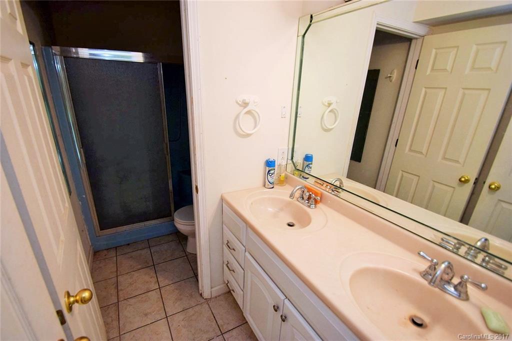 2503 Trinity Church Road Monroe, NC 28112 - Photo 14 of 24 a bathroom with a sink a toilet a mirror and shower