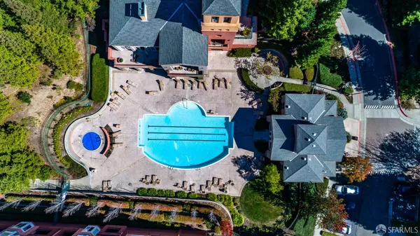 an aerial view of a house with garden space and street view