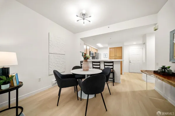 a view of a dining room with furniture and wooden floor