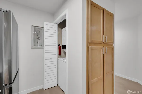 a view of a hallway with closet and door