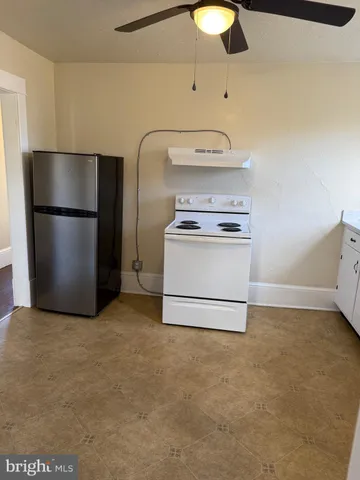 a kitchen with a stove and a refrigerator