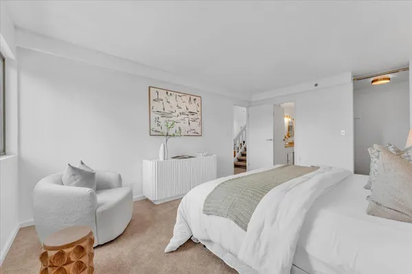 a bedroom with a bed and a couch