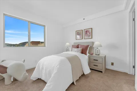 a bedroom with a bed and a chair