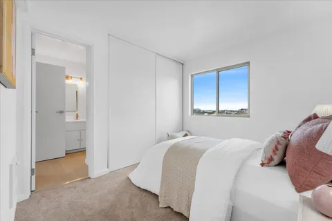 a bedroom with a bed and a mirror