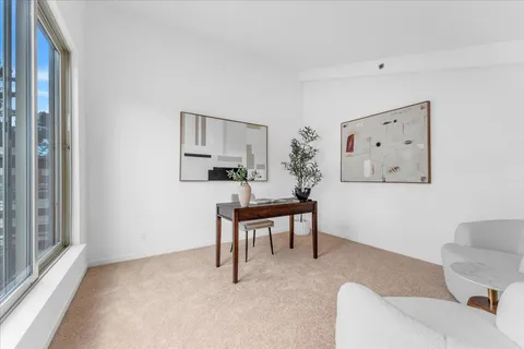 a living room with furniture a window and a table