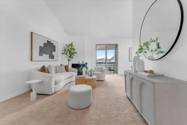 a living room with furniture a mirror and a painting on the wall