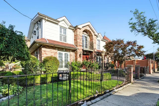 a front view of a house with a garden and plants