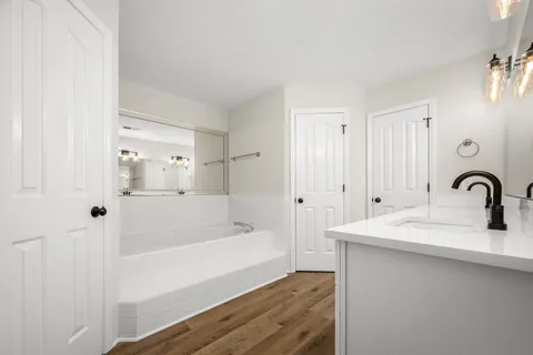 a bathroom with a bathtub and a sink