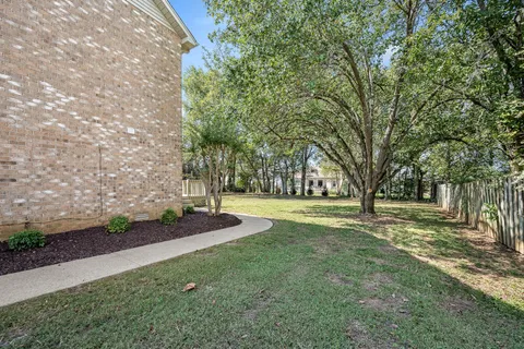 a huge green field with lots of trees
