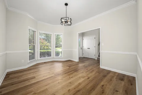 a view of wooden floor and windows in a room
