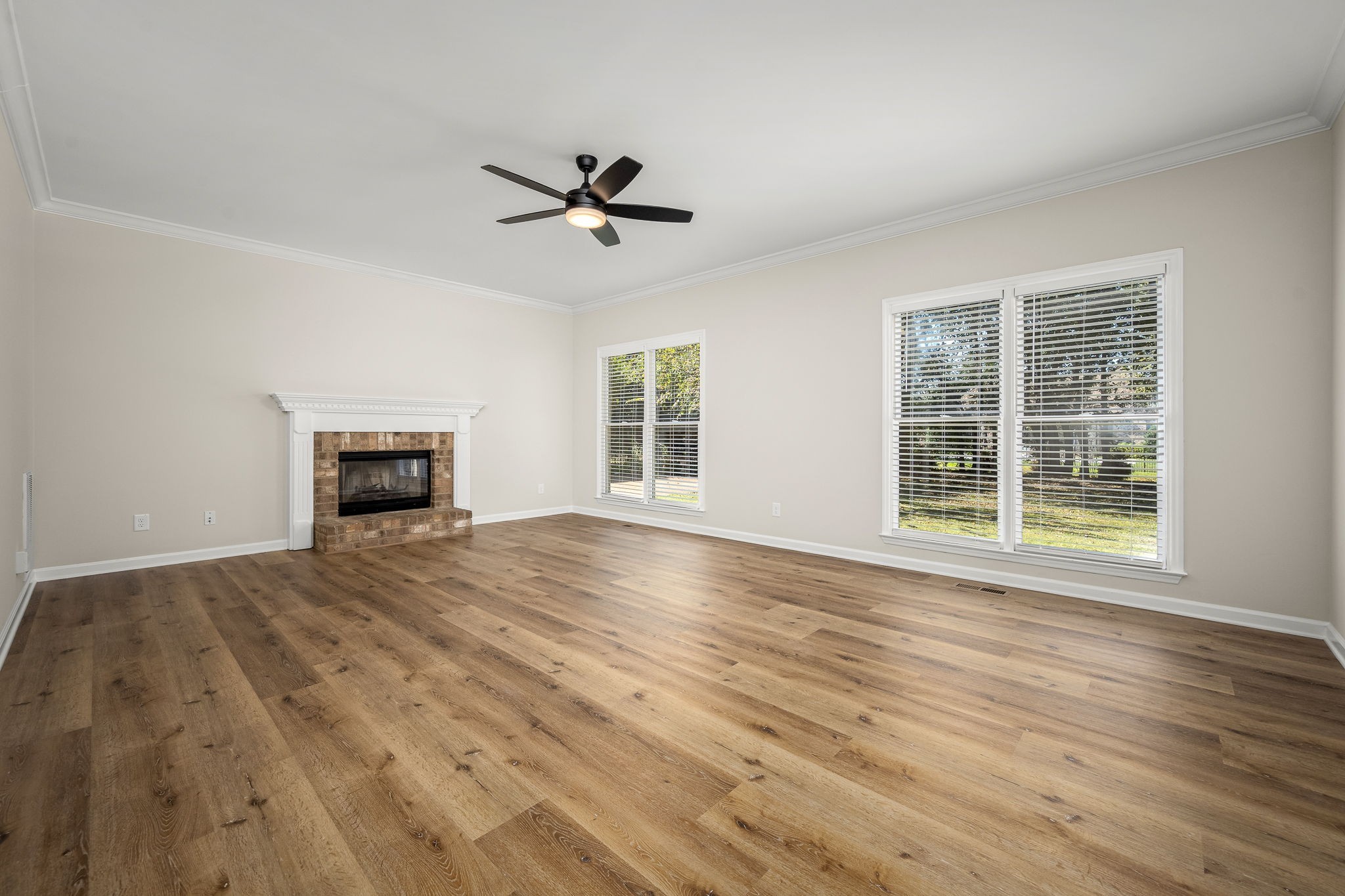 2923 Regenwood Drive Murfreesboro, TN 37129 - Photo 9 of 34 a view of empty room with wooden floor and fireplace