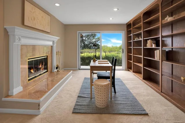 a view of living room kitchen with stainless steel appliances granite countertop furniture and a window