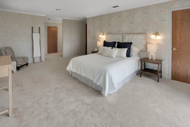 a view of a hallway with wooden floor and windows