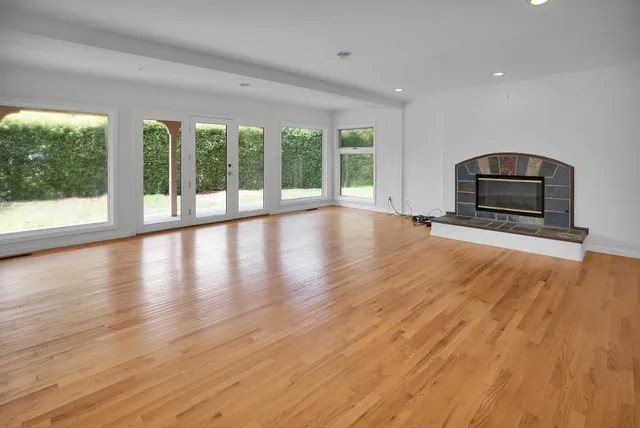 a view of kitchen with stainless steel appliances granite countertop cabinets and wooden floor