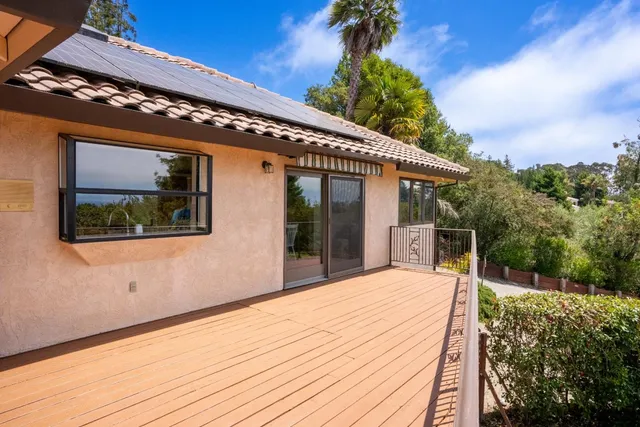 an aerial view of a house with a yard and lake view