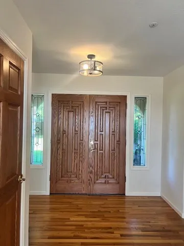 a dining room with furniture and wooden floor