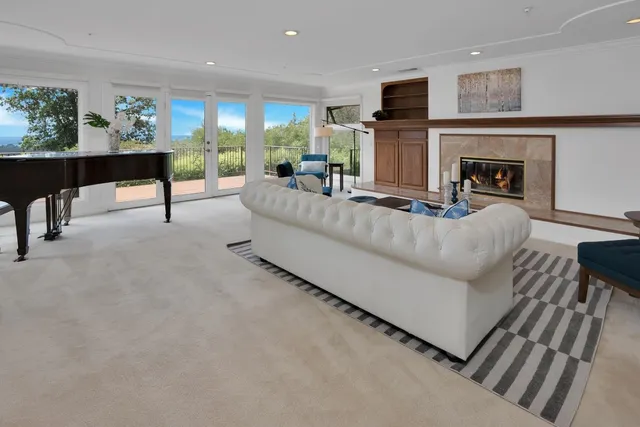 a kitchen with stainless steel appliances kitchen island granite countertop a table chairs in it and wooden floors