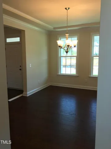 a view of a room window and wooden floor