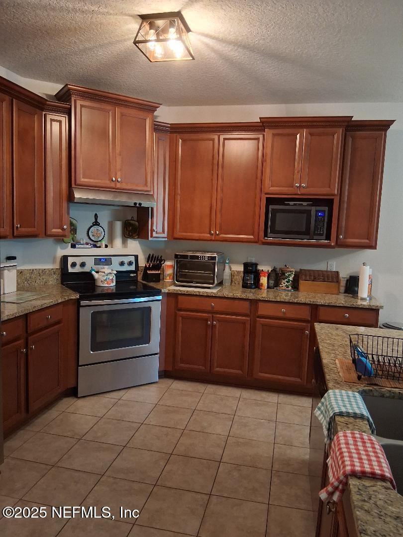 96028 Coral Reef Road Yulee, FL 32097 - Photo 12 of 33 stained cabinets